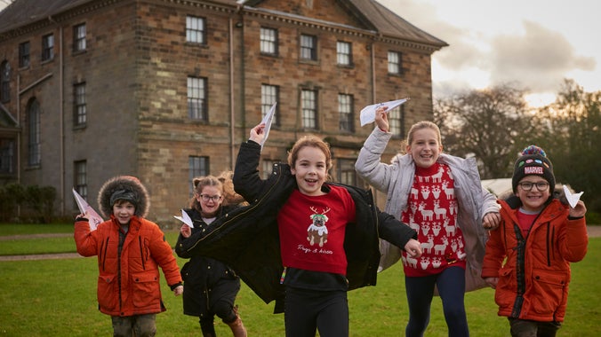 Young visitors exploring the park during their visit at Christmas at Ormesby Hall, North Yorkshire